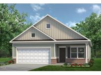 Charming one-story home featuring a two-car garage, green lawn, and manicured landscaping at 291 Deodora Ln, Cameron, NC 28326