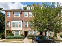 Charming brick townhouse with stone accents, lush landscaping, and a well-manicured front yard at 3103 Stockdale Dr, Raleigh, NC 27609