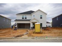 Under-construction two-story home features a modern white exterior, a dark roof, and an attached garage at 3409 Rosebush Dr, Zebulon, NC 27597