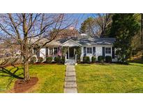 Charming home with a well-manicured lawn and inviting front porch and a path to the front door at 508 Currituck Dr, Raleigh, NC 27609