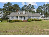Charming single-story home with a cozy front porch and well-maintained landscaping at 664 Marler Rd, Benson, NC 27504