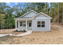 Charming single-story home with a modern gray exterior and inviting front entrance at 111 Halifax Rd, Louisburg, NC 27549
