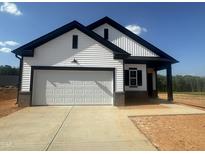 New construction home featuring white siding, black trim, a two-car garage, and a concrete driveway at 11778 Salers Loop, Middlesex, NC 27557