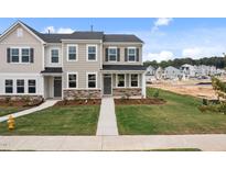 Charming new construction townhomes with manicured lawns and stone accents in a desirable community at 2313 Kasota Ln, Raleigh, NC 27610