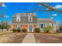 Charming two-story home with brick and vinyl siding, blue shutters and a neatly manicured lawn at 2319 Somers Ave, Burlington, NC 27215