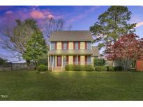 Charming two-story home featuring blue siding, red shutters and a cozy front porch at 3808 Johnson Pond Rd, Apex, NC 27539