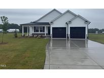 Charming single-story home with a two-car garage, covered porch, and well-manicured lawn at 47 Silver Ct, Smithfield, NC 27577