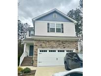 Two-story home with stone accents, attached garage, and well-maintained front yard at 50 Teal Dr, Youngsville, NC 27596