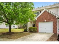 Charming townhome featuring a one-car garage and well-maintained front yard with a beautiful tree at 528 Summer Storm Dr, Durham, NC 27704