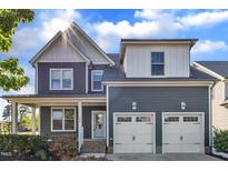 Charming two-story home features a two-car garage, lovely front porch, and manicured landscaping at 706 Fireball Ct, Knightdale, NC 27545