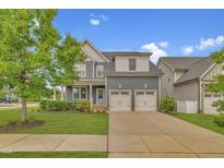 Charming two-story home showcasing a well-manicured lawn and a convenient two-car garage at 706 Fireball Ct, Knightdale, NC 27545