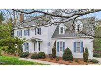 Charming two-story home with white siding, blue shutters, and a well-manicured front yard at 7201 Jonathan Dr, Wendell, NC 27591