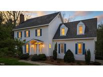 Charming two-story home with blue shutters and welcoming front entrance at dusk at 7201 Jonathan Dr, Wendell, NC 27591