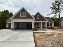 Charming single-Gathering home featuring a three-car garage and inviting craftsman style architecture at 104 Roma Gora Ct, Princeton, NC 27569