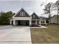 Beautiful two-story home featuring a large driveway, attached garage, and inviting front porch at 104 Roma Gora Ct, Princeton, NC 27569