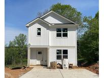Charming new construction home with vertical siding and covered porch at 112 Remington Woods Dr, Wake Forest, NC 27587