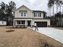 Charming two-story home featuring a two-car garage and a well-manicured front yard at 131 Wilderness Trl, Smithfield, NC 27577