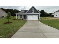 Charming home with a well-manicured lawn and a spacious two-car garage at 147 Tuskeegee Dr, Smithfield, NC 27577