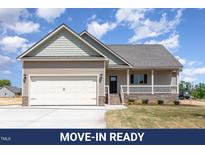 Charming single-Gathering home with a two-car garage, covered porch and neutral siding at 163 Royal Ave, Selma, NC 27576