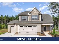 Charming two-story home with a three-car garage and well-maintained landscaping at 18 Bonnybrook Ct, Selma, NC 27576