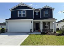 Charming two-story home with a two-car garage, well-manicured lawn, and inviting curb appeal at 18 W Emily Gardens Dr, Selma, NC 27576