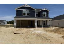 Two-story home featuring navy siding and a two-car garage in a new residential community at 18 W Emily Gardens Dr, Selma, NC 27577