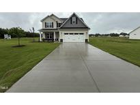 Inviting two-story home featuring a well-maintained lawn and a spacious two-car garage at 21 Trescott St, Smithfield, NC 27577