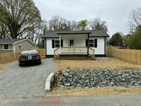 Charming cottage-style home with a cozy front porch, fresh landscaping, and a newly graveled driveway at 2316 Radiance Dr, Burlington, NC 27215