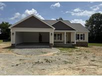 Charming single-story home featuring a large, attached two-car garage and inviting front porch at 28 Bailey-Boykin Rd, Selma, NC 27576