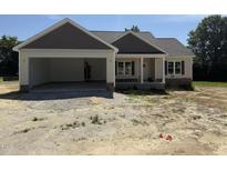 Charming single-story home with a two-car garage and covered entryway, set on a spacious lot at 28 Bailey-Boykin Rd, Selma, NC 27576