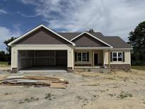 New construction home showing the exterior with an attached two-car garage and stone accents at 28 Bailey-Boykin Rd, Selma, NC 27576