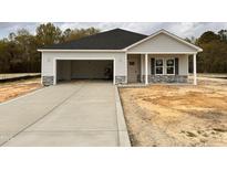 New construction home with attached garage, gray siding, stone accents, and covered front porch at 282 Trescott St, Smithfield, NC 27577