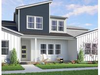 Beautiful two-story home featuring modern architecture, lush landscaping, and a welcoming front porch at 815 Central Park Dr, Knightdale, NC 27604