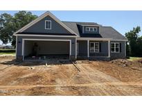 Charming home exterior with gray siding, stone accents, and an attached two-car garage at 40 Bailey-Boykin Rd, Selma, NC 27576