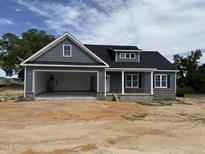 Charming single-story home boasts an attached two-car garage and a covered front porch at 40 Bailey-Boykin Rd, Selma, NC 27576