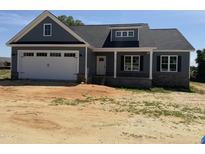 Charming craftsman-style home with a two-car garage and stone accents, offering modern curb appeal at 40 Bailey-Boykin Rd, Selma, NC 27576