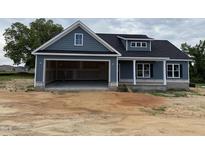 New construction home with blue siding, two-car garage, and a charming front porch at 40 Bailey-Boykin Rd, Selma, NC 27576