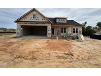 New home under construction with a two-car garage and covered porch at 40 Bailey-Boykin Rd, Selma, NC 27576