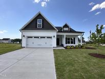 Charming single-Gathering home with a two-car garage, manicured lawn, and classic black and white exterior at 40 Tuskeegee Dr, Smithfield, NC 27577