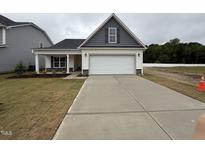 Charming single-Gathering home with a two-car garage and craftsman-style details at 41 W Emily Gardens Dr, Selma, NC 27576