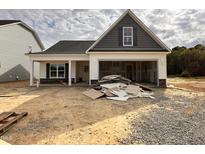 New construction home featuring a charming exterior with stone accents and an attached garage at 41 W Emily Gardens Dr, Selma, NC 27576