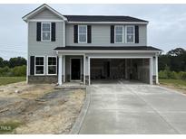 Two-story home with gray siding, black shutters, and a spacious two-car garage at 43 Chloe Ct, Selma, NC 27577