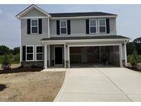 Two-story home featuring gray siding, black shutters, and an attached two-car garage at 43 Chloe Ct, Selma, NC 27577