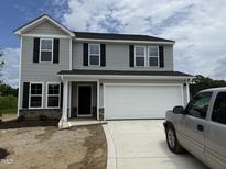 Two-story home with gray siding, black shutters, and a two-car garage on a concrete driveway at 43 Chloe Ct, Selma, NC 27576