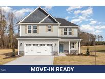 Charming two-story home with a two-car garage and stone accents at 46 Lupin Dr, Smithfield, NC 27577