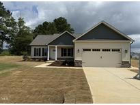 Charming single-story home featuring a two-car garage and a welcoming front yard landscape at 47 Royal Ave, Selma, NC 27576