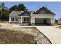 Charming one-story home showcasing a welcoming front entrance and an attached two-car garage at 47 Royal Ave, Selma, NC 27576