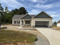 New construction home with a two-car garage, neutral siding, and stone accents at 47 Royal Ave, Selma, NC 27576