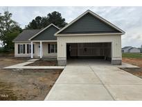 Charming single-Gathering home featuring a two-car garage and manicured landscaping at 47 Royal Ave, Selma, NC 27576