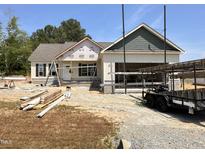 Under-construction single story home featuring light siding and a two car garage at 47 Royal Ave, Selma, NC 27576